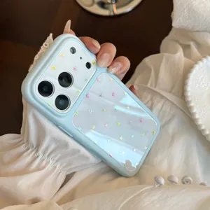Close-up of light blue iPhone case with holographic colorful star patterns.