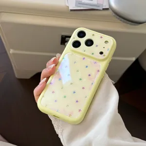Detailed view of a pastel yellow iPhone case featuring a colorful holographic star pattern