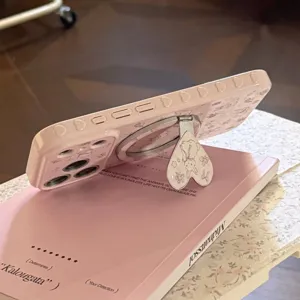 Close-up detail of a pink magnetic phone case with cute bunny print and heart-shaped stand