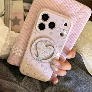 Close-up of a pink iPhone case with cartoon rabbit print and heart-shaped ring stand.