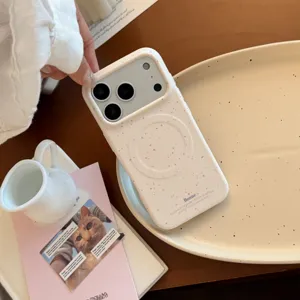 Vue détaillée d'une coque iPhone crème avec des taches roses et un anneau magnétique