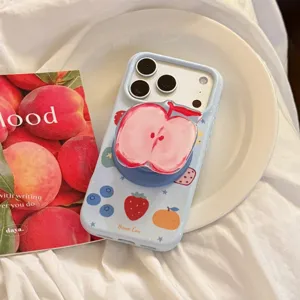 Close-up of light blue iPhone case with fruit graffiti and apple-shaped pop socket.