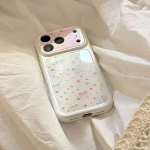 Detailed view of cream glitter iPhone case decorated with colorful stars and cute bowknots