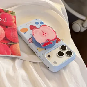 Cute light blue iPhone case with fruit graffiti and 3D apple-shaped phone grip stand.