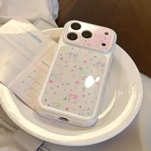 Close-up of a white iPhone phone case decorated with colorful stars and elegant bowknot patterns.