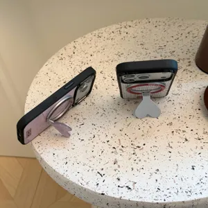Close-up of vintage striped and wood grain iPhone cases with magnetic heart stands