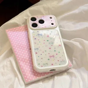 Detail showing a white iPhone case with cute colorful stars and bow knots pattern