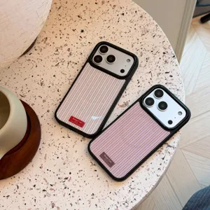 Close-up of vintage striped iPhone cases with Bonne Case branding on a stone table