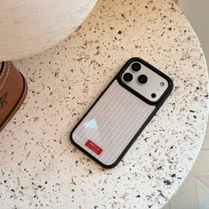Vintage red striped iPhone case with Bonne Case logo on a textured table surface.