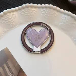 Close-up of vintage heart-shaped magnetic phone grip with The Lucky Star design