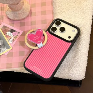 Detailed view of striped iPhone case with pink heart magnetic ring grip.