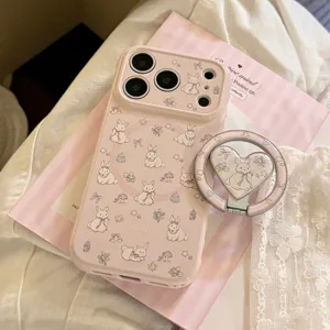 Close-up of pink iPhone case with cute cartoon bunny patterns and matching heart ring
