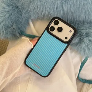 Close-up detail of a stylish blue striped iPhone case with unique text held in hand