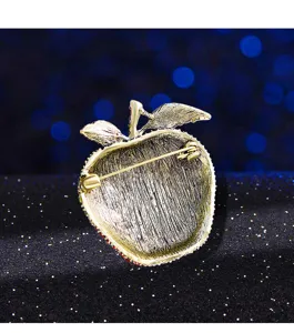 Detailed back view of a vintage apple rhinestone brooch showing the secure safety pin clasp