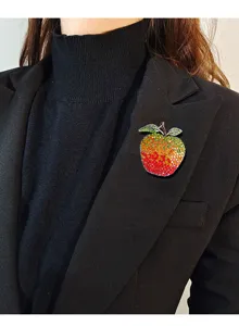 Detail of vintage apple brooch with colorful rhinestones on a black blazer lapel.