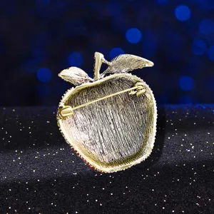 Vintage apple-shaped brooch with a golden finish and secure pin back closure for suits.