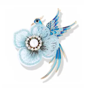 Exquisite macro detail of blue handmade embroidered flower and enamel phoenix bird brooch