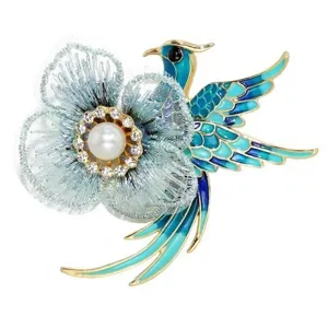 Detail of vintage embroidered phoenix bird brooch with flower and pearl accents
