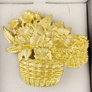 Detailed macro view of a golden matte flower basket brooch featuring intricate leaf textures