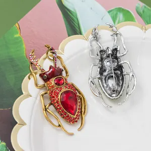 Detailed view of punk beetle brooch showing intricate rhinestone inlay and back clasp