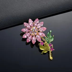 Macro-detail van roze zonnebloem broche met fonkelende strass-steentjes en bladeren