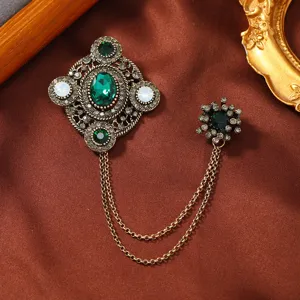 Vintage emerald green rhinestone brooch with gold tassel chain for unisex suit collars