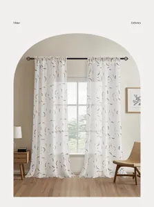 Wabi-sabi style sheer curtains with golden printed patterns in a cozy living room