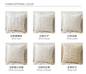 Selection of plush pillow covers with various embroidered 3D patterns in white and beige