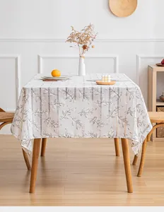 Detailed view of hollow striped tablecloth with elegant leaf pattern on wooden table