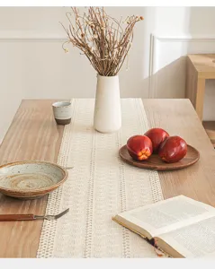 Bohemian woven linen cotton table runner with hollow design in a rustic dining scene