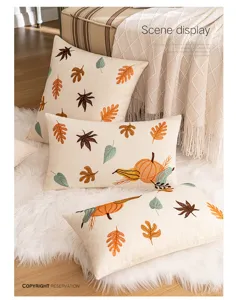 Detailed view of autumn pumpkin and maple leaf embroidered pillowcases in home scene