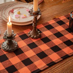 Orange and black buffalo plaid Halloween table runner for festive party dining decor
