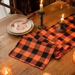 Halloween orange and black buffalo plaid table runner for spooky party table decor
