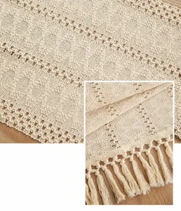 Close-up of bohemian macramé table runner with intricate hollow patterns and tassels