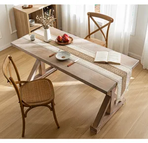 Bohemian style woven jute and cotton table runner with tassels on a wooden dining table
