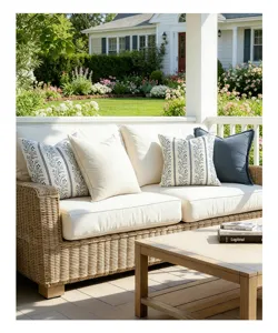 Close-up of vintage floral pattern pillow covers on a stylish outdoor wicker sofa