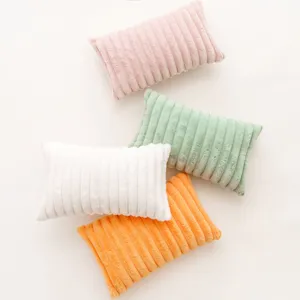 Set of four modern ribbed plush pillowcases in pink, mint, white, and orange colors.