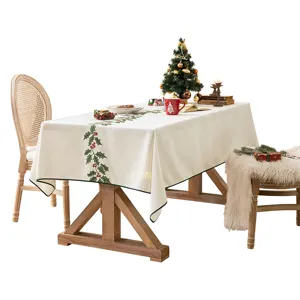 Mantel navideño festivo con elegante bordado de bayas rojas y hojas de acebo verde.