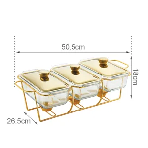 Detail view of the 3-compartment glass buffet food warmer with gold metal stand and lids.