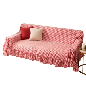 Red and white checkered sofa cover featuring a decorative ruffled hem design