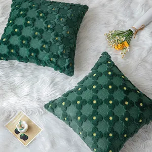 Set of dark green plush pillow covers featuring 3D floral patterns on a soft white fur rug