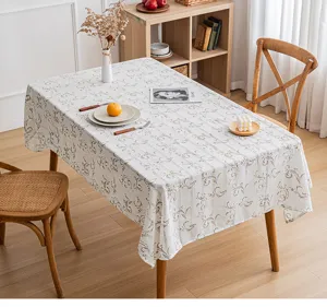 Elegant floral print tablecloth with hollow-out stripe detail in a warm home setting