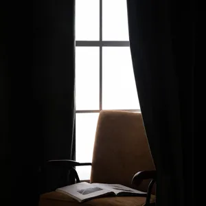 Elegant black velvet hook-style blackout curtains for living room in minimalist scene