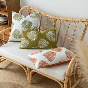 Chenille pumpkin throw pillow covers displayed on a rattan sofa in a cozy home interior