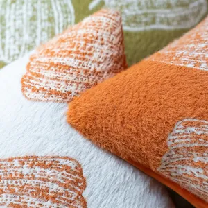 Close-up of soft orange and white chenille pumpkin pillow covers with fuzzy texture