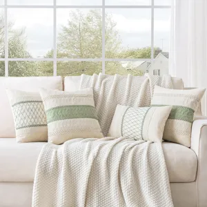 Rustic farmhouse style woven cotton pillow covers and matching throw blanket on sofa
