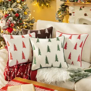 Set of Christmas tree embroidered chenille throw pillow covers on sofa with festive decor