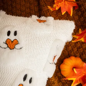 Cozy Halloween white plush pillow featuring a cute embroidered ghost with orange heart.