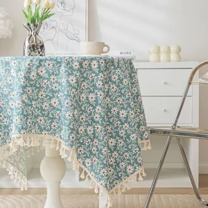 Vintage floral tablecloth with tassels on a dining table in a cozy home setting