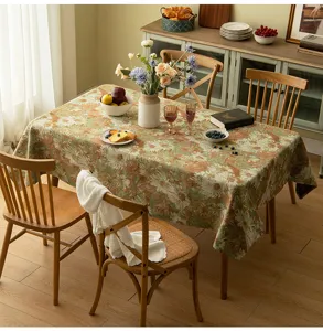 Vintage floral jacquard tablecloth on a wooden dining table in a cozy home setting